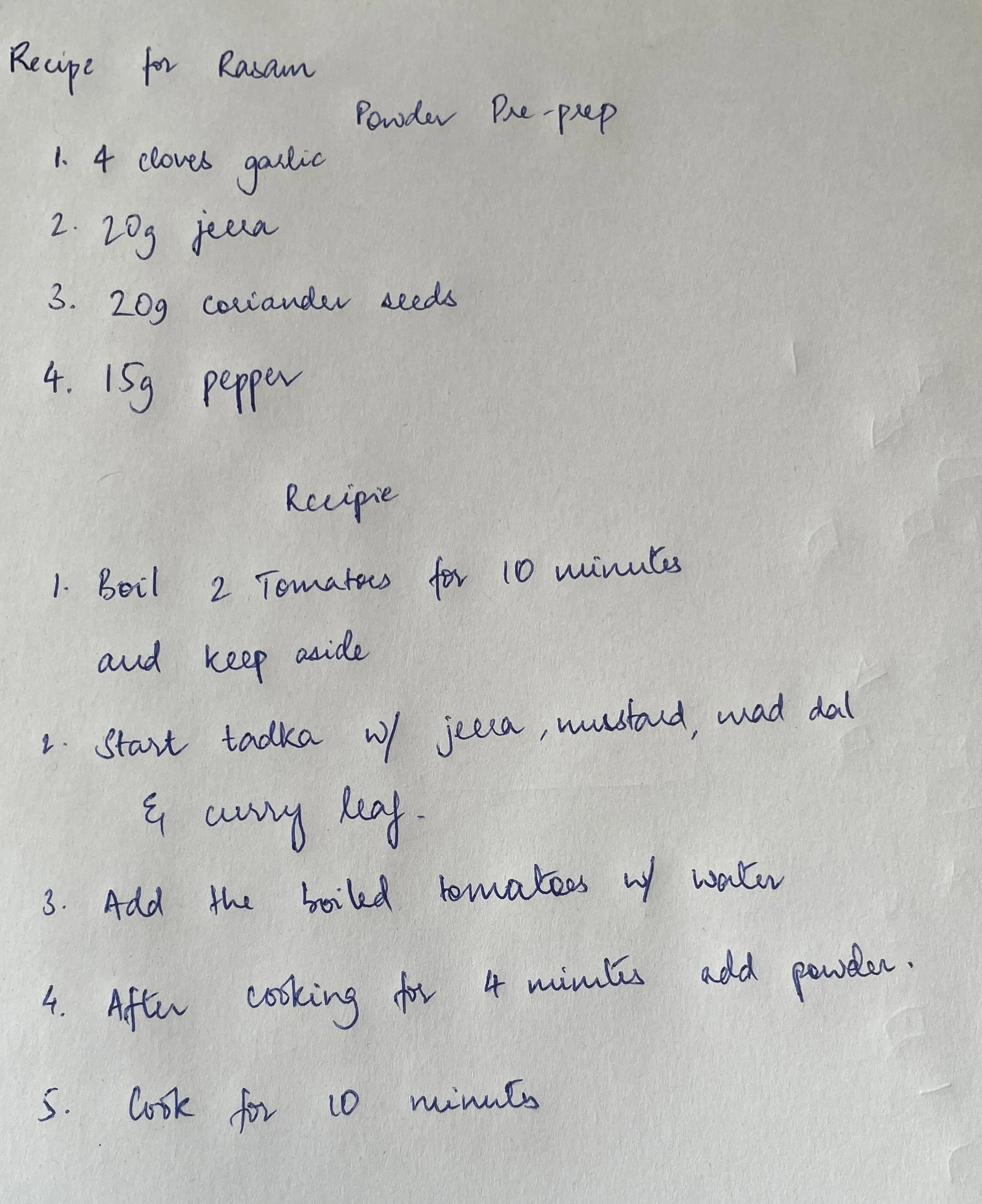 Traditional family recipe for rasam showing handwritten ingredients and instructions